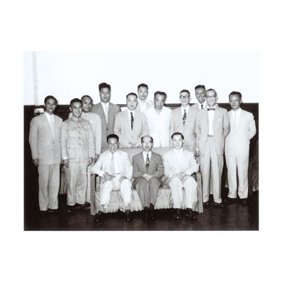 民國四十六年七月一日，第一任主任委員嚴家淦先生（前排中）偕第二任主任委員蔣經國先生與工作伙伴合影，後立左起第二位為作者劉士溱。